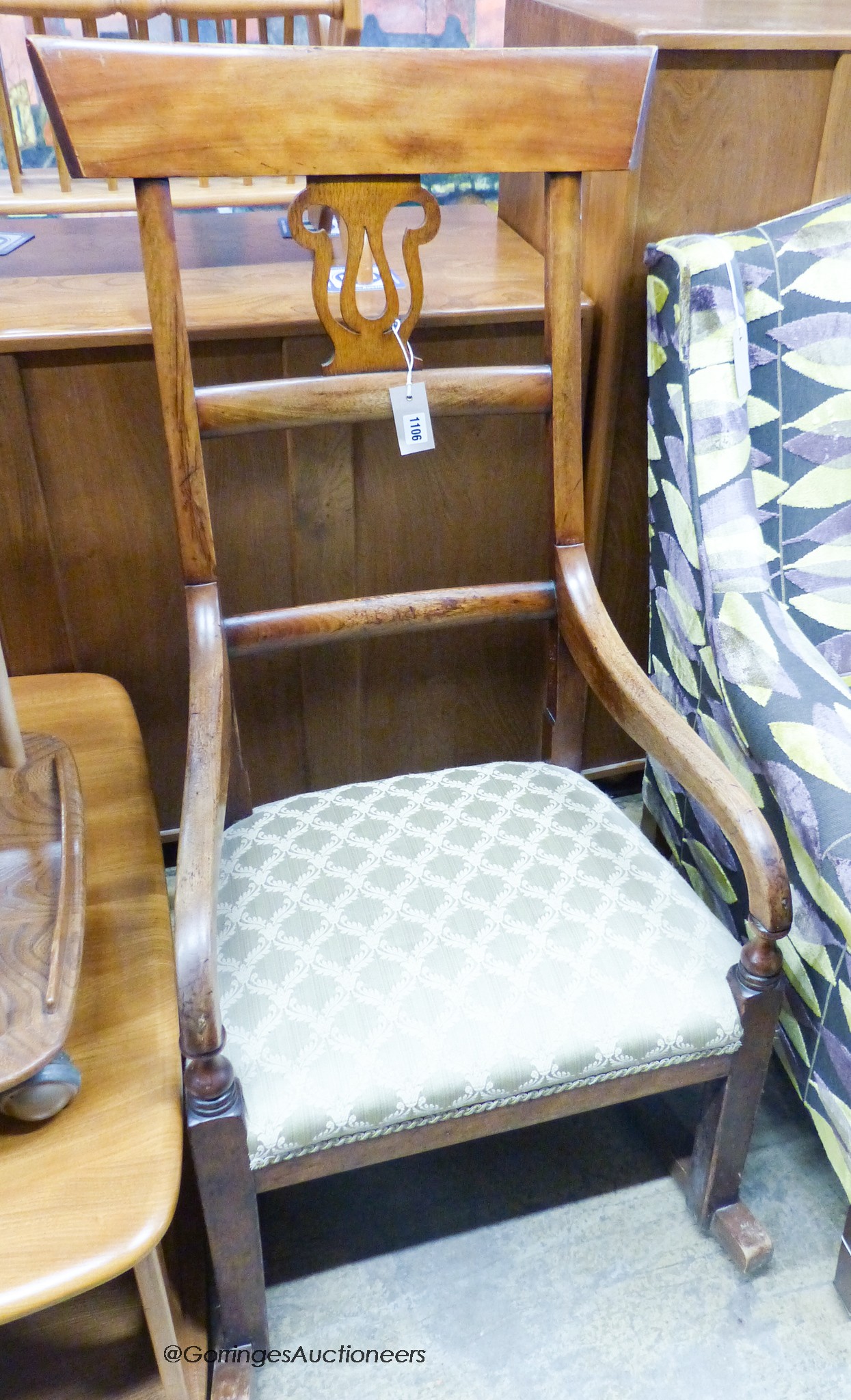 An early 19th century provincial fruitwood rocking elbow chair